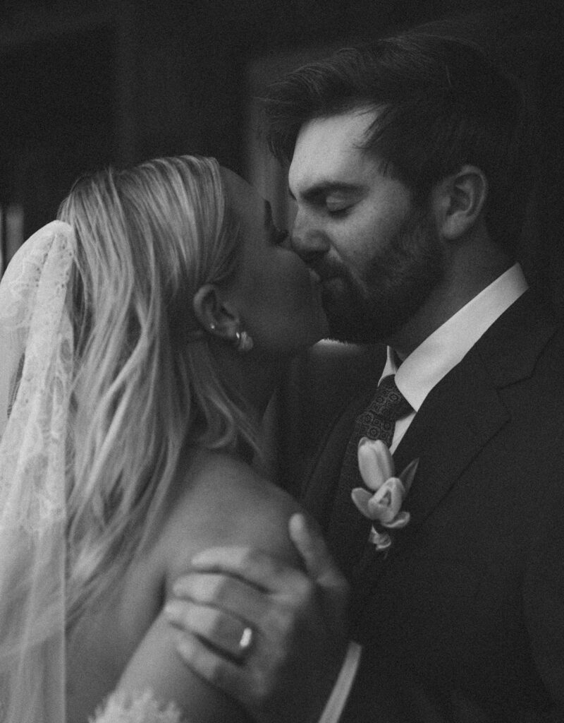 documentary style wedding photography bride and groom kissing