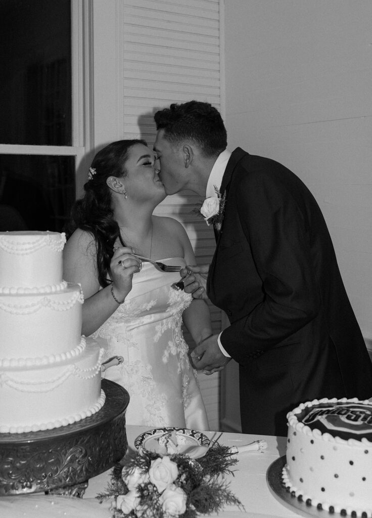 bride and groom cutting their wedding cake during wedding reception