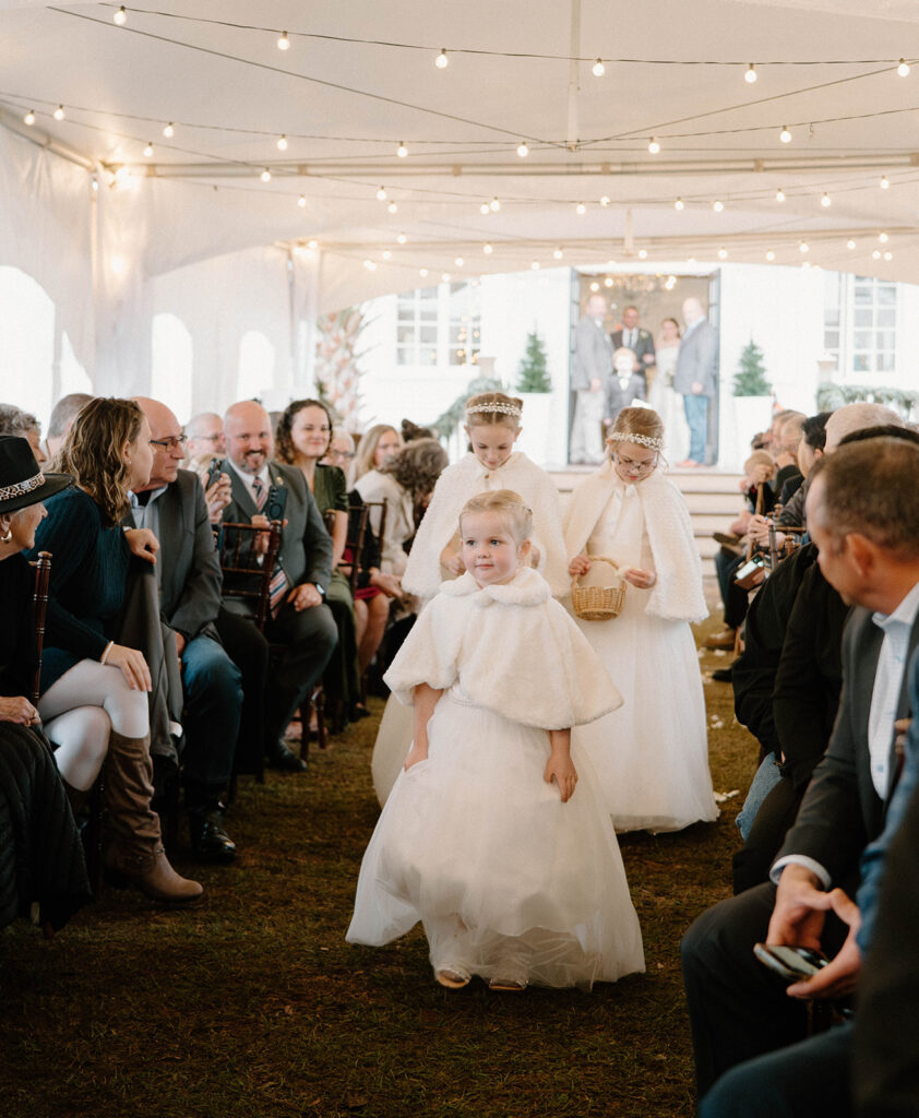 cozy winter wedding ceremony with twinkling lights and Christmas trees