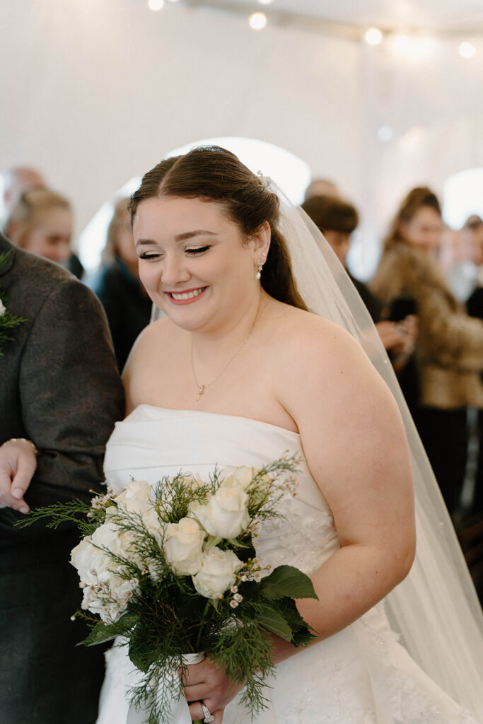 cozy winter wedding ceremony with twinkling lights and Christmas trees