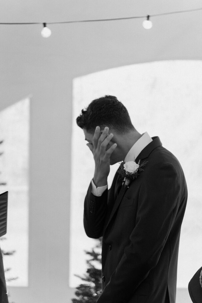documentary style wedding photography groom wiping tears