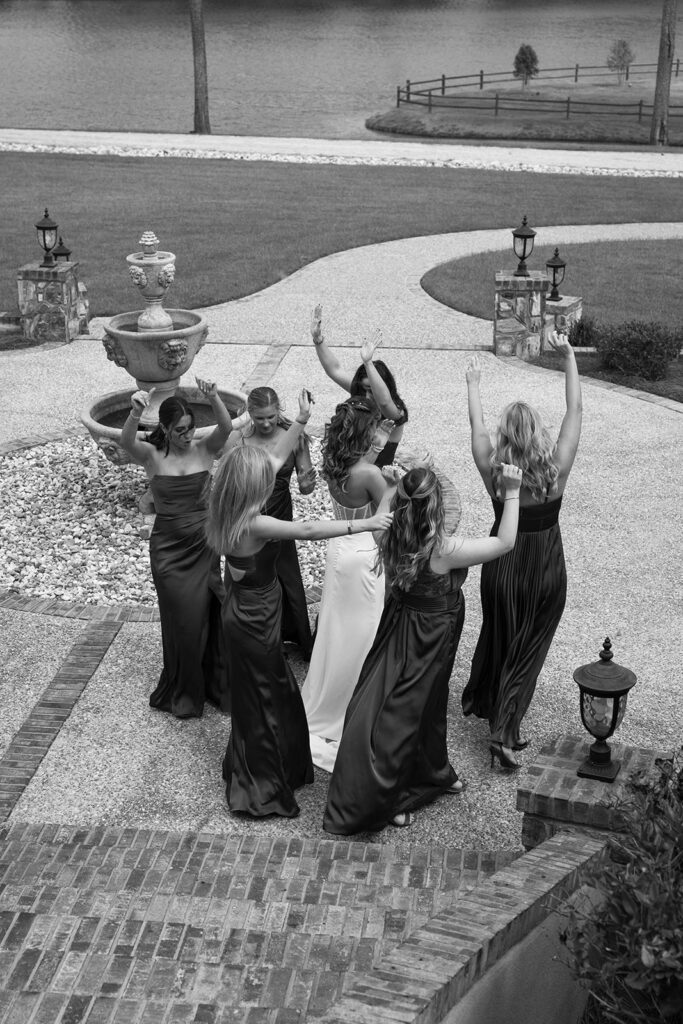 bride dancing with bridesmaids on the wedding day