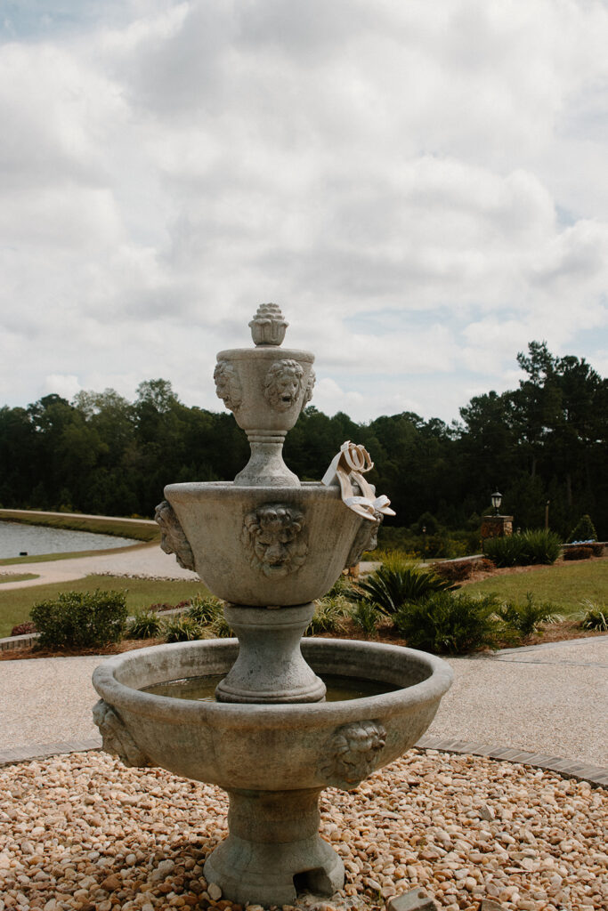 bride heels placed on top of a water fountain