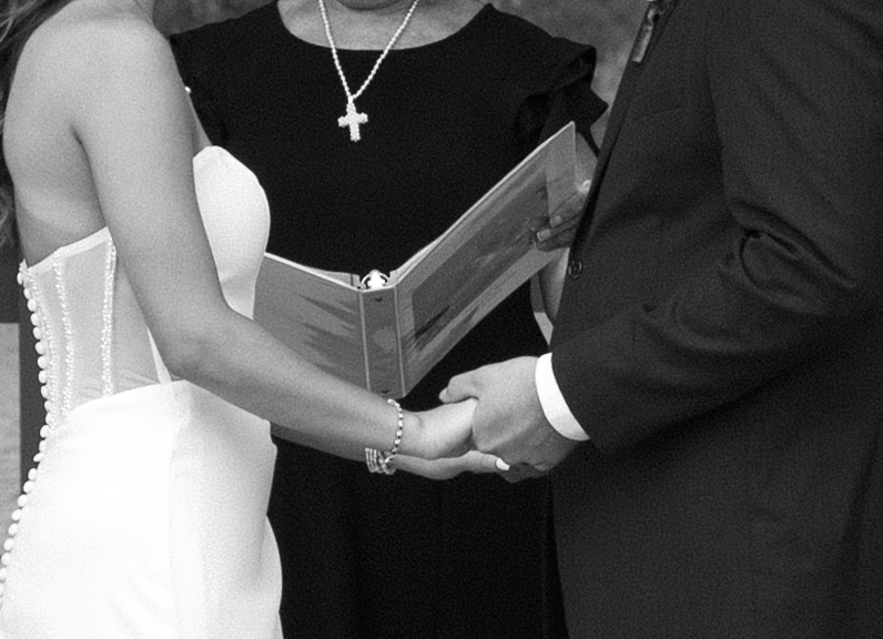 bride and groom holding hands during the ceremony