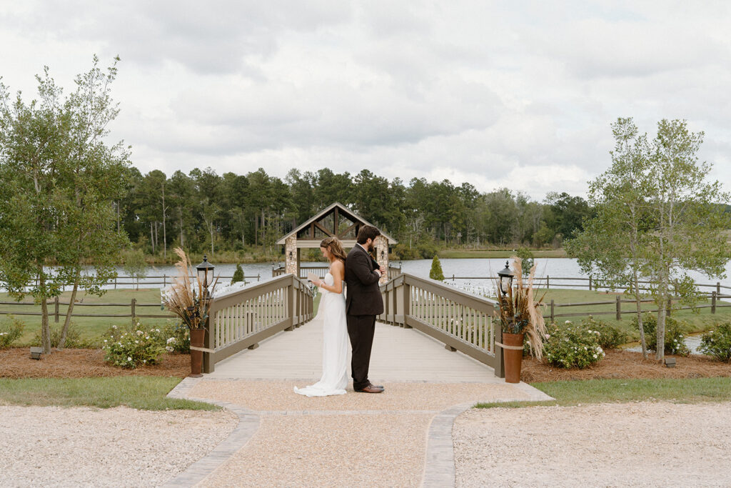 first touch with the bride and groom with a waterfront view at southwind plantation