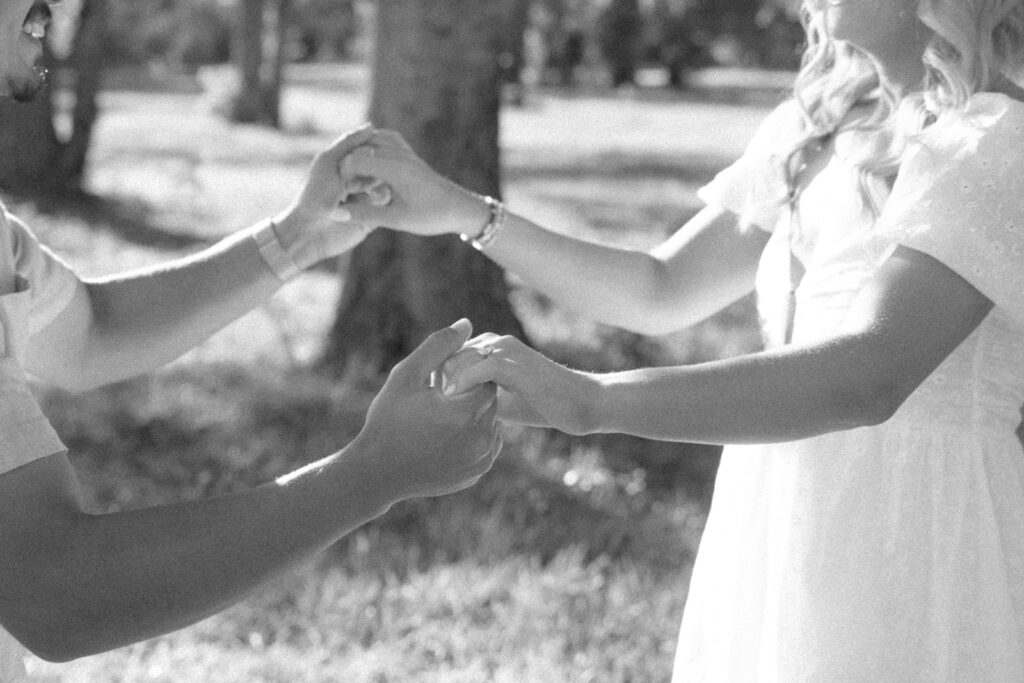couple holding hands in front of mount pleasant lodge