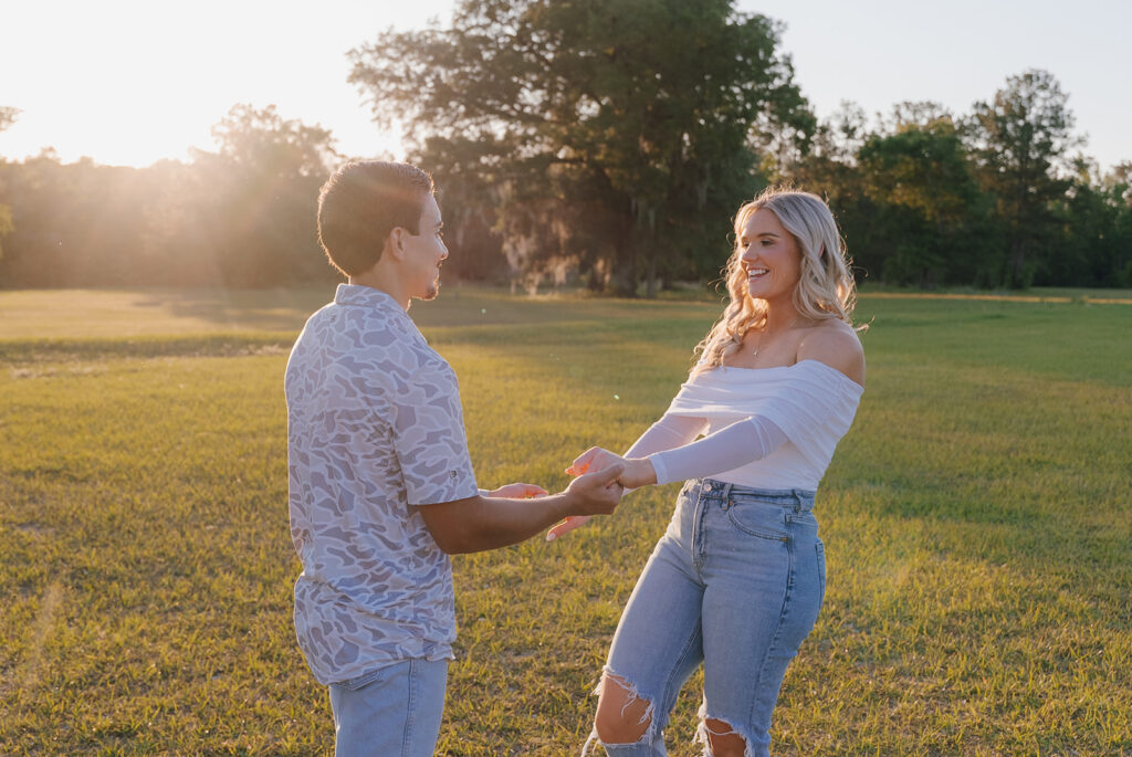 couple running around in a field in florida