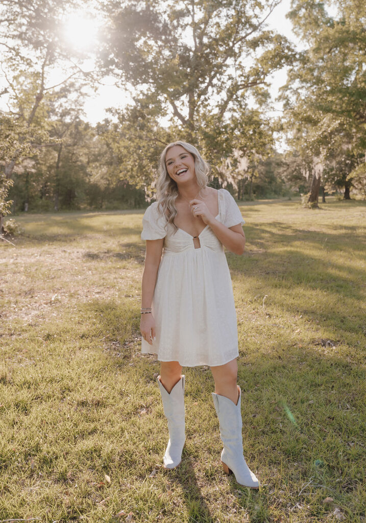 girl smiling at fiance and holding initial necklace
