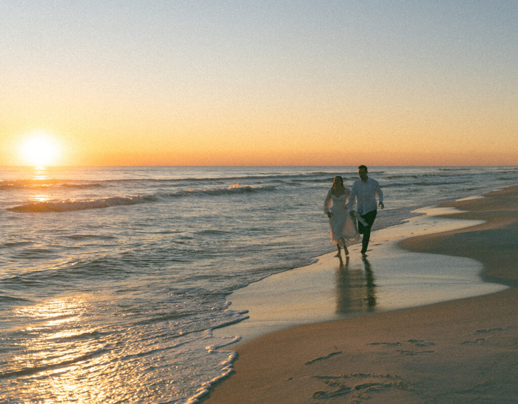Documentary style sunset portraits of newlyweds on the beach