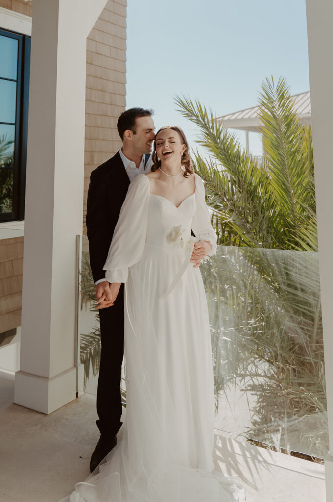 Bride and groom laughing together.