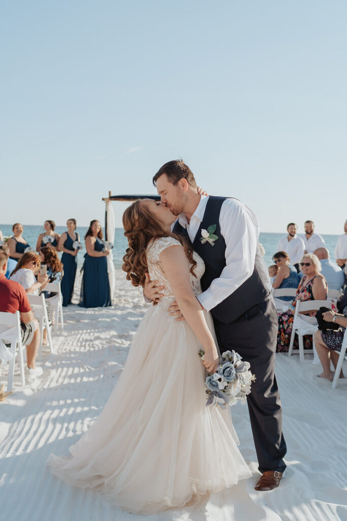 Bride and groom kissing after their beach wedding ceremony in 30A.