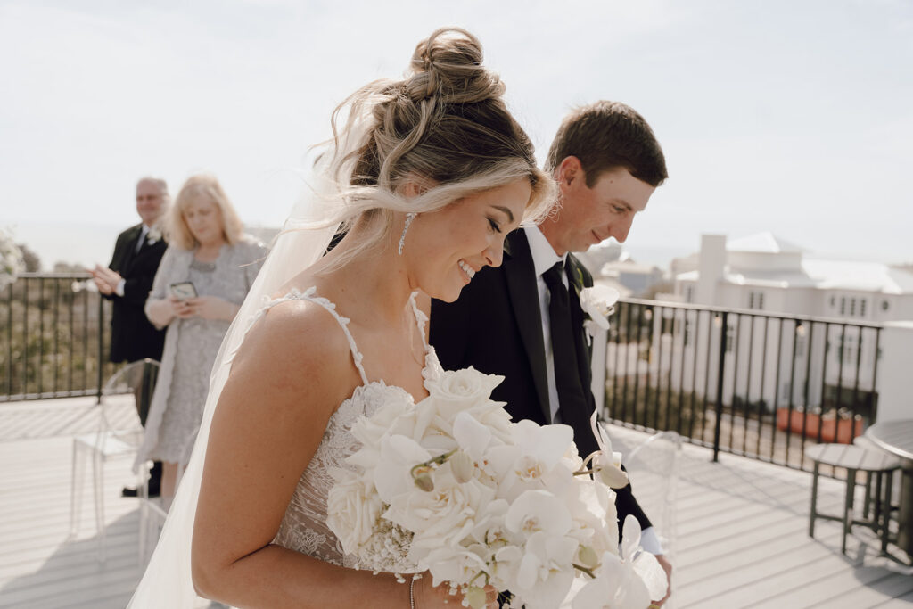 Bride and groom walking down the aisle during their 30A beach wedding.