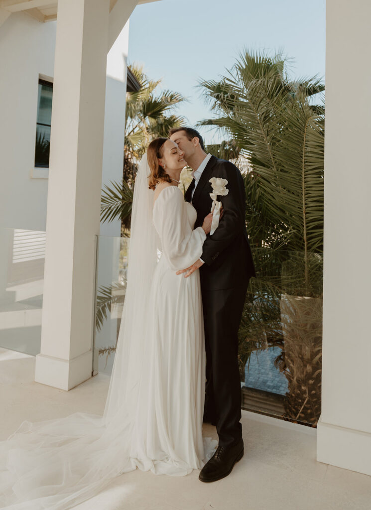 Groom kissing his soon-to-be wife before the 30A beach wedding.