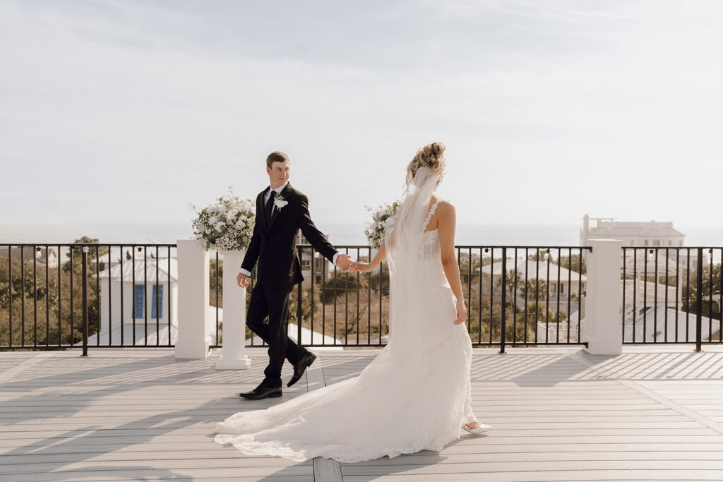 Bride and groom walking around the rooftop of their 30A beach wedding.