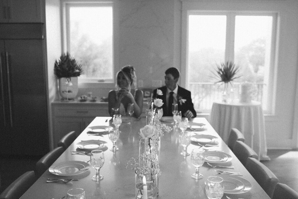 Bride and groom sitting at a table for dinner.