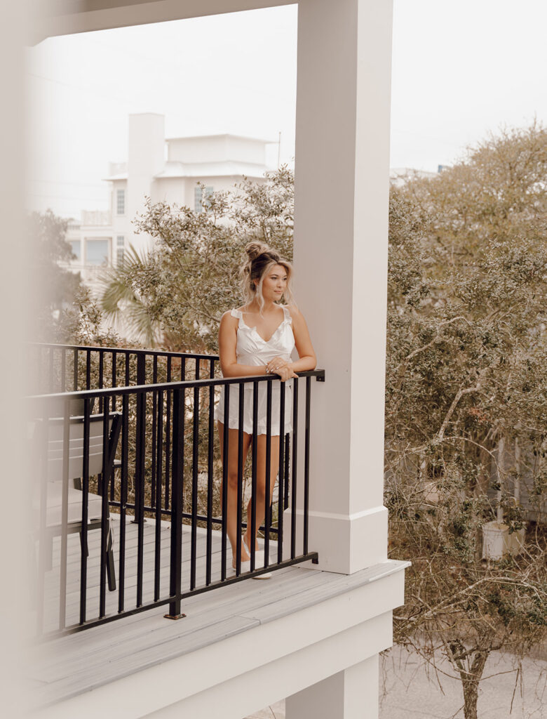 A bride looking out into the distance before her 30A beach wedding.