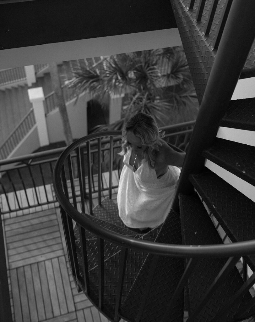 A bride walking up a staircase at her wedding in the Bahamas.