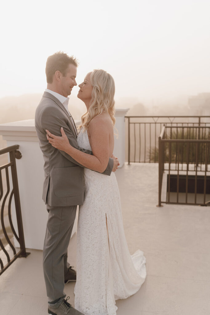 Bride and groom holding one another on the rooftop of their wedding in the Bahamas.