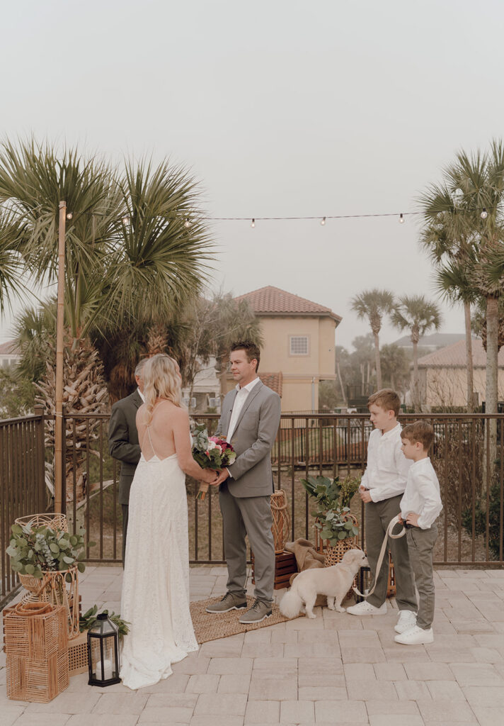 Bride and groom holding hands during their Bahamas destination wedding ceremony.