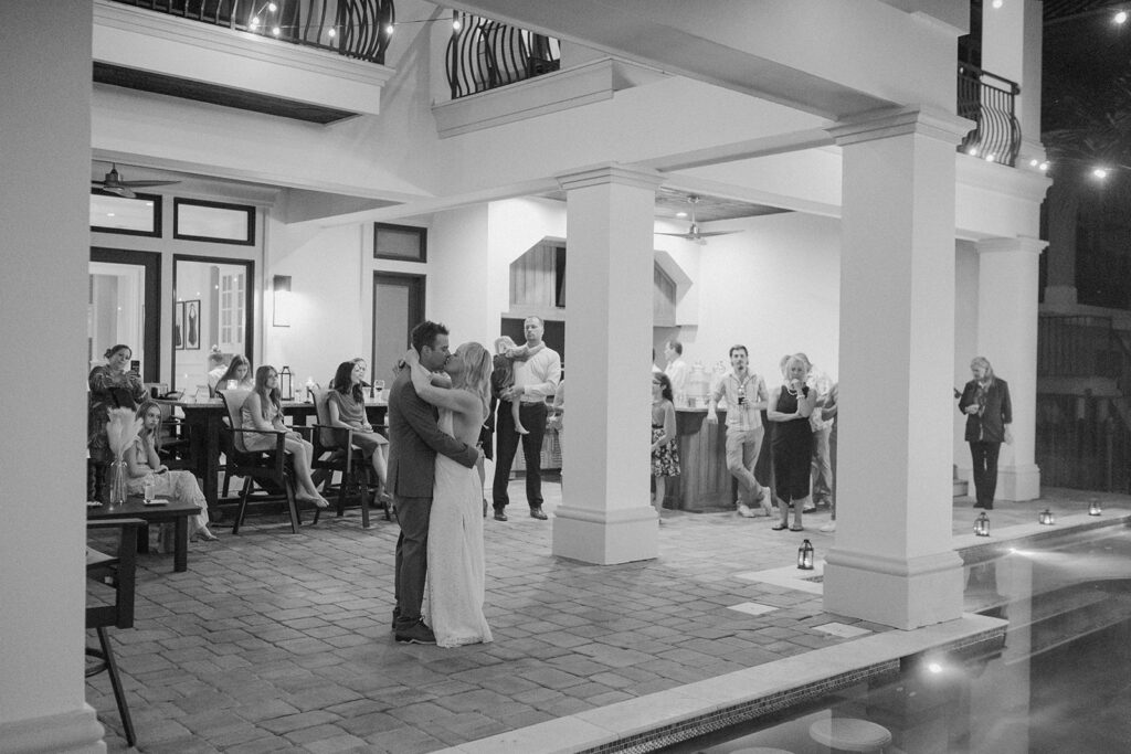 Bride and groom slow dancing while guests watch during their Bahamas destination wedding.