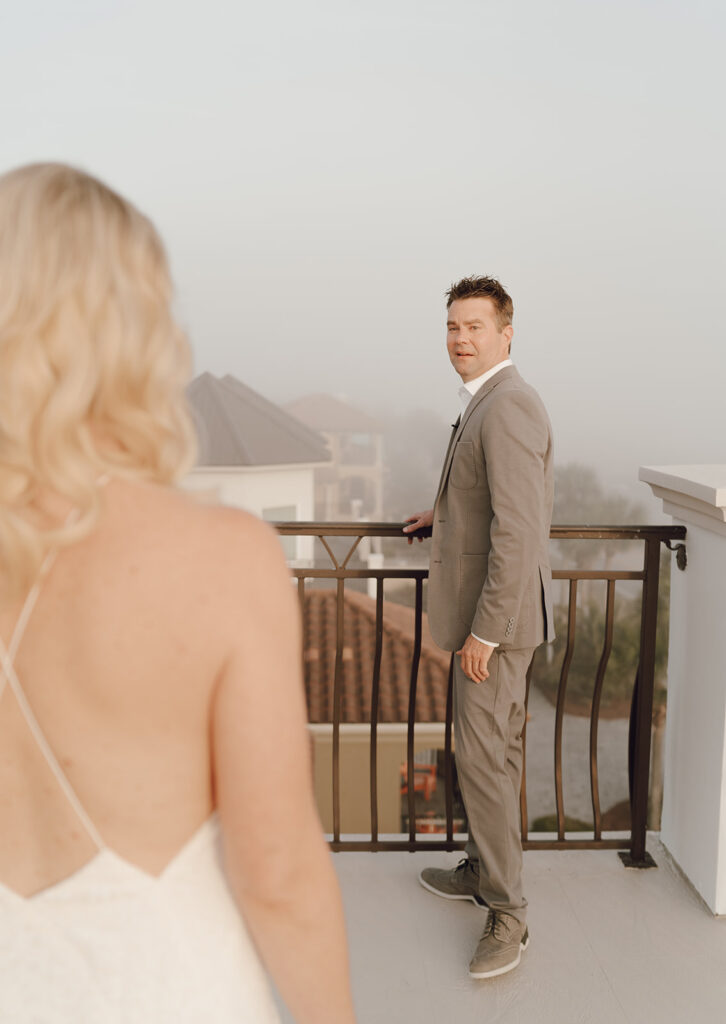 A groom seeing his bride for the first time during their first look at their destination wedding in the Bahamas.