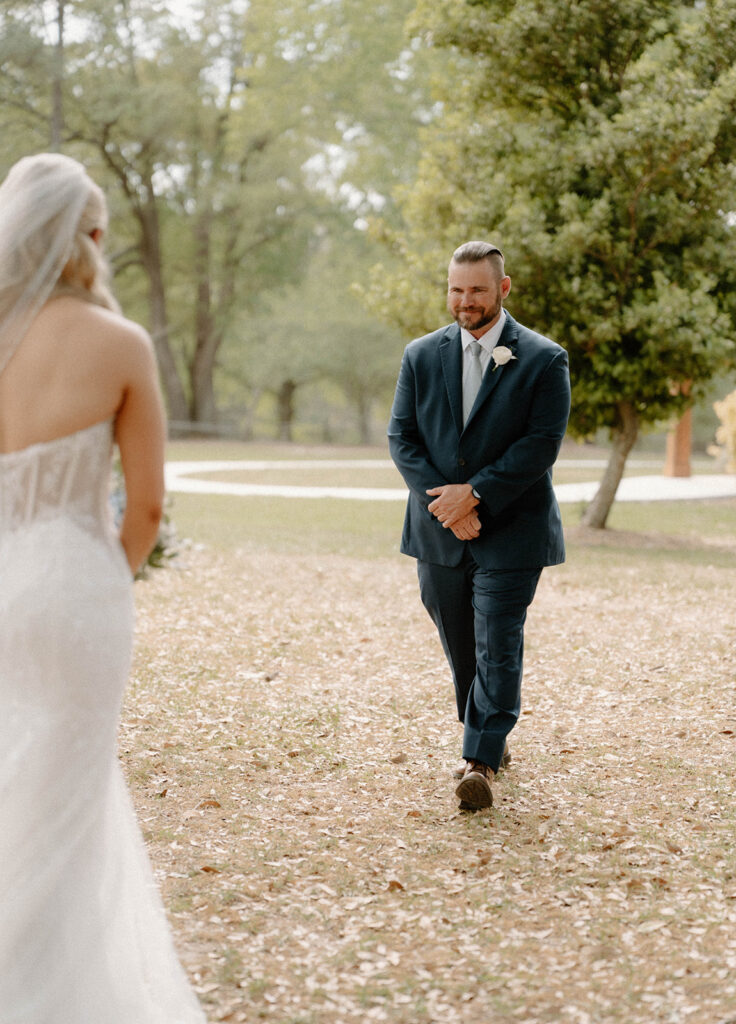 Father of the bride walking towards the bride.