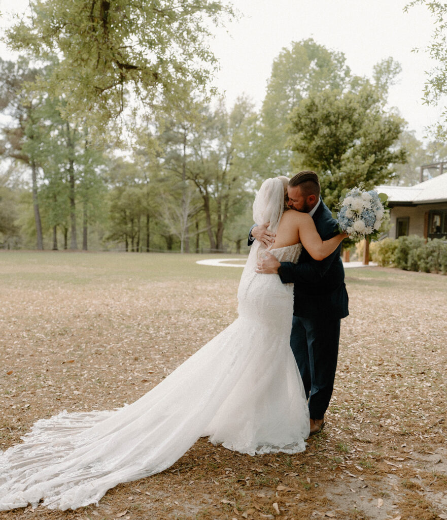 Father of the bride hugging his daughter during their first look at Mount Pleasant Lodge.