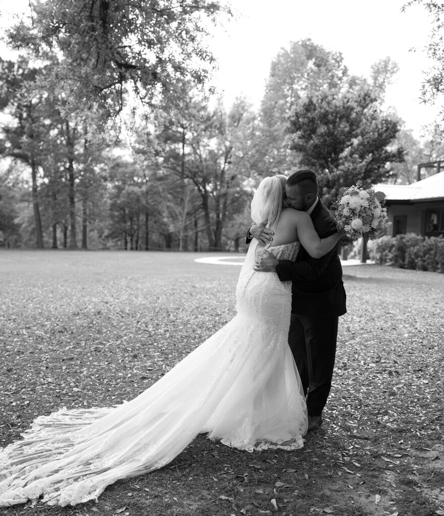 Father of the bride hugging the bride.