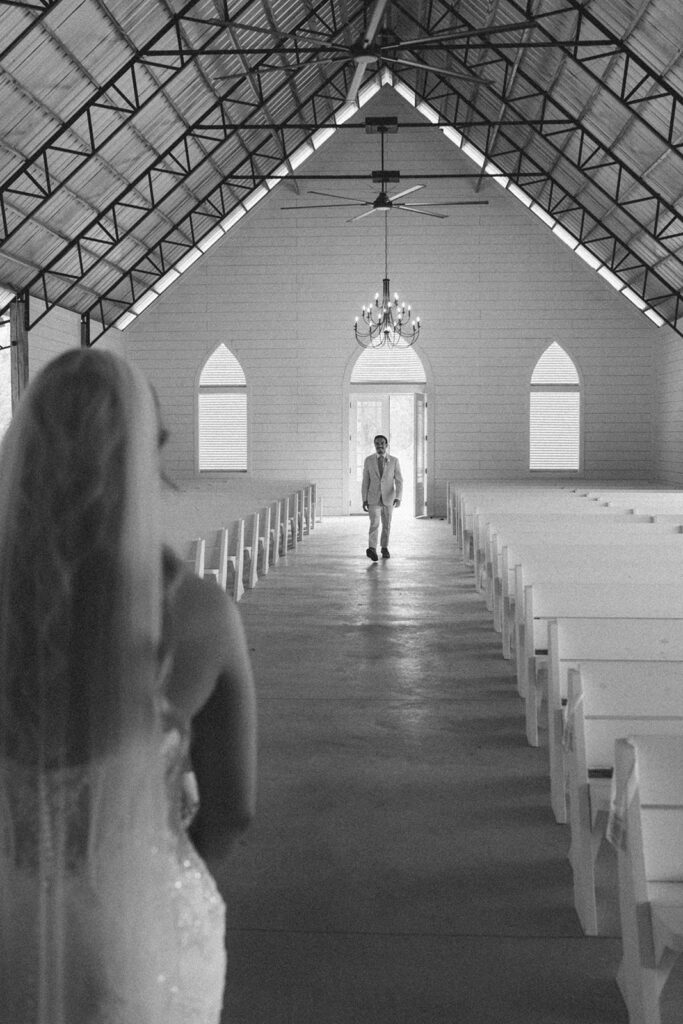 Groom walking towards the bride for their first look.
