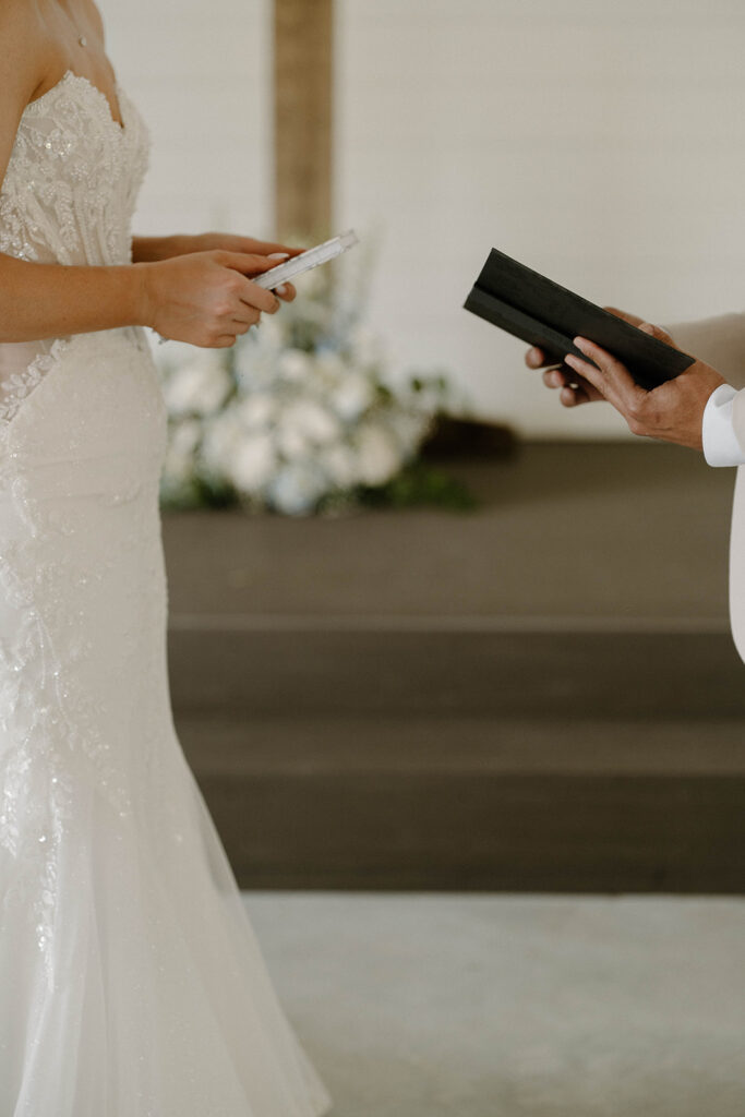 Bride and groom holding their vow books.