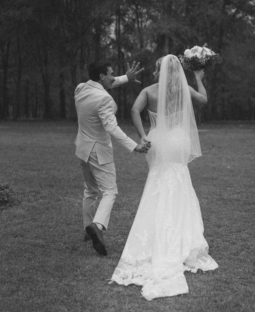 Bride and groom waving as they exit the ceremony.