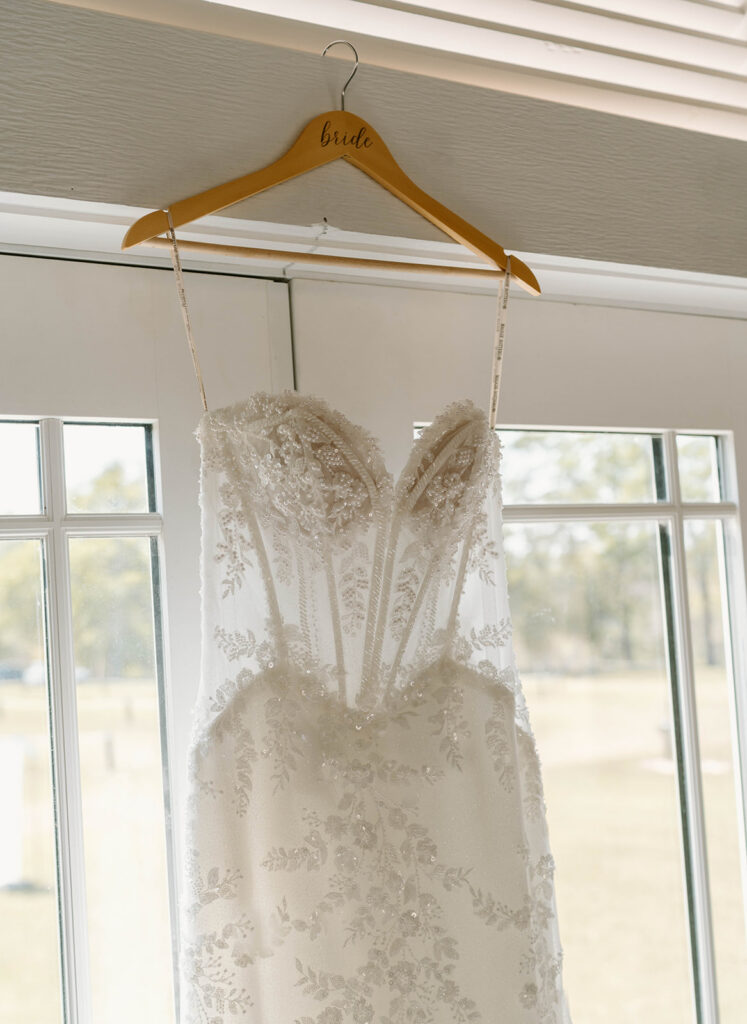 Close up of the wedding dress hanging in the chapel at Mount Pleasant Lodge in Florida.