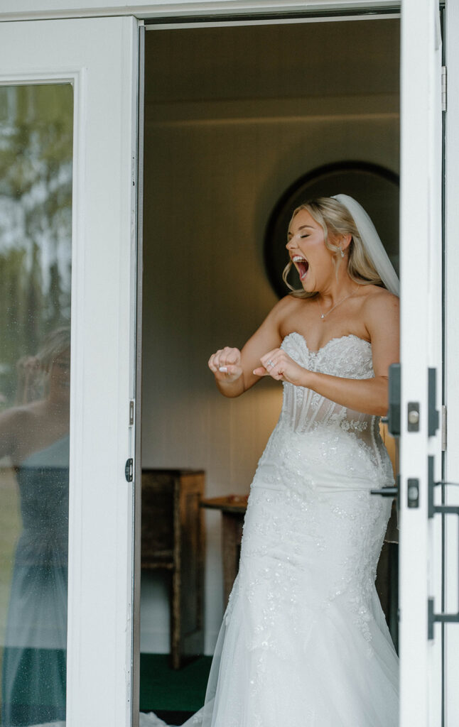Bride playfully dancing for candid wedding photos.