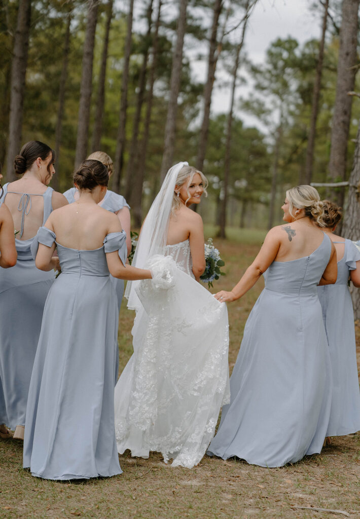 Bridal party walking around for candid wedding photos outside.