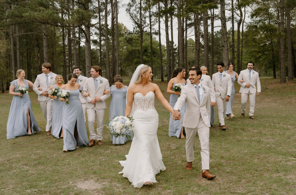 Wedding party walking outside of Mount Pleasant Lodge.