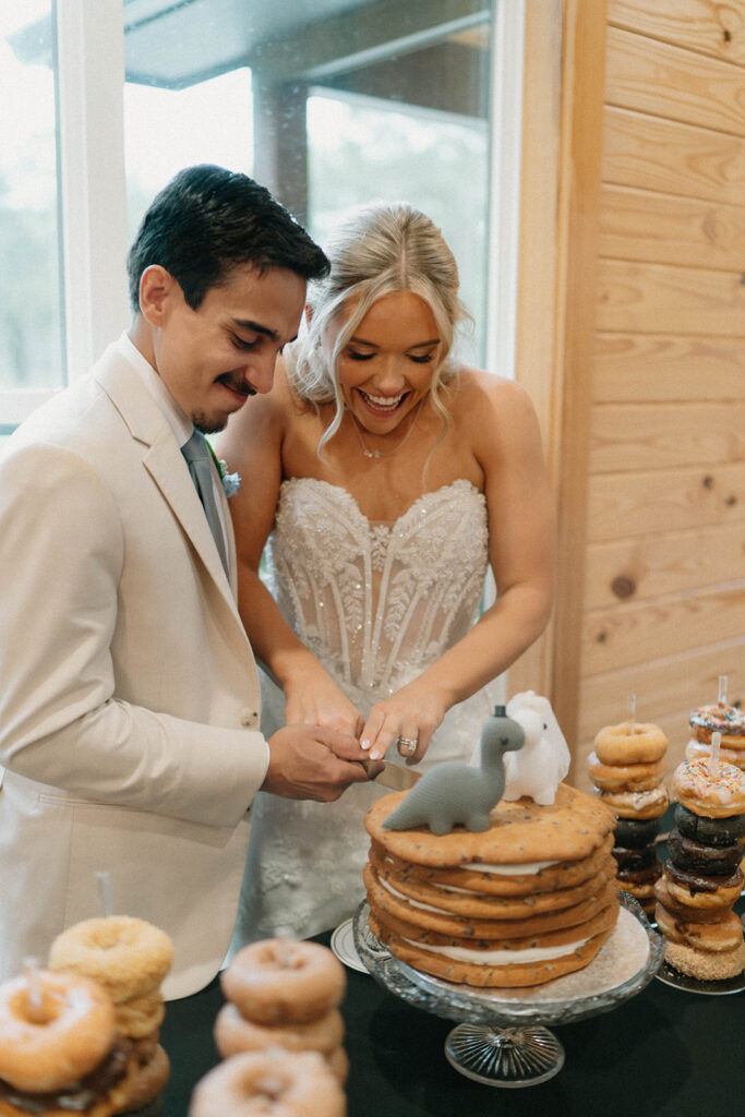 Bride and groom cutting a cookie cake at their reception at Mount Pleasant Lodge in FL.