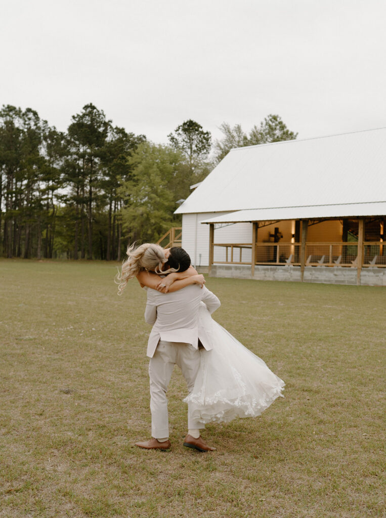 Groom spinning his bride around outside of Mount Pleasant Lodge.