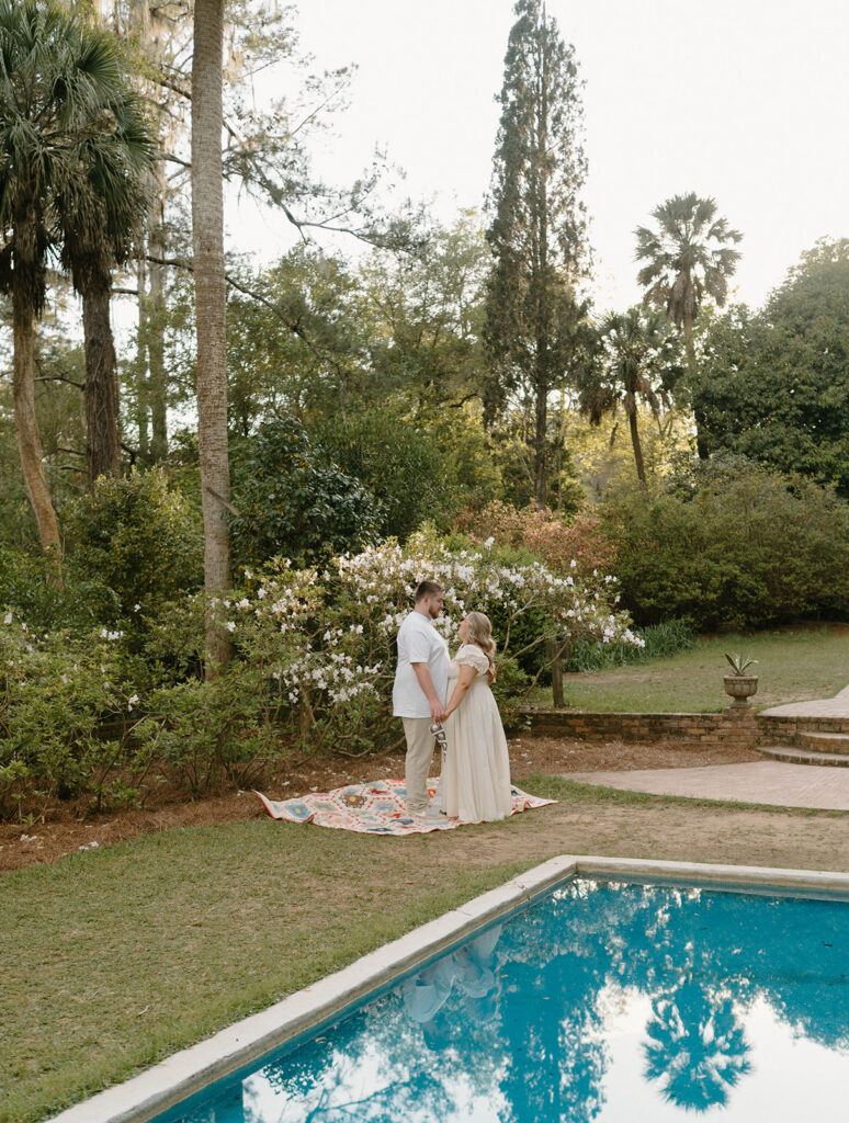 Couple holding hands by a pool of water for Alfred B Maclay Gardens State Park photos.