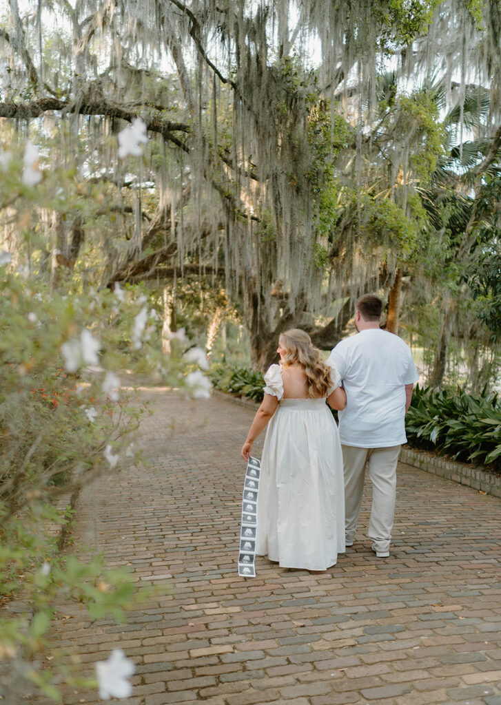 Couple waling along a brick road for Alfred B Maclay Gardens State Park photos.