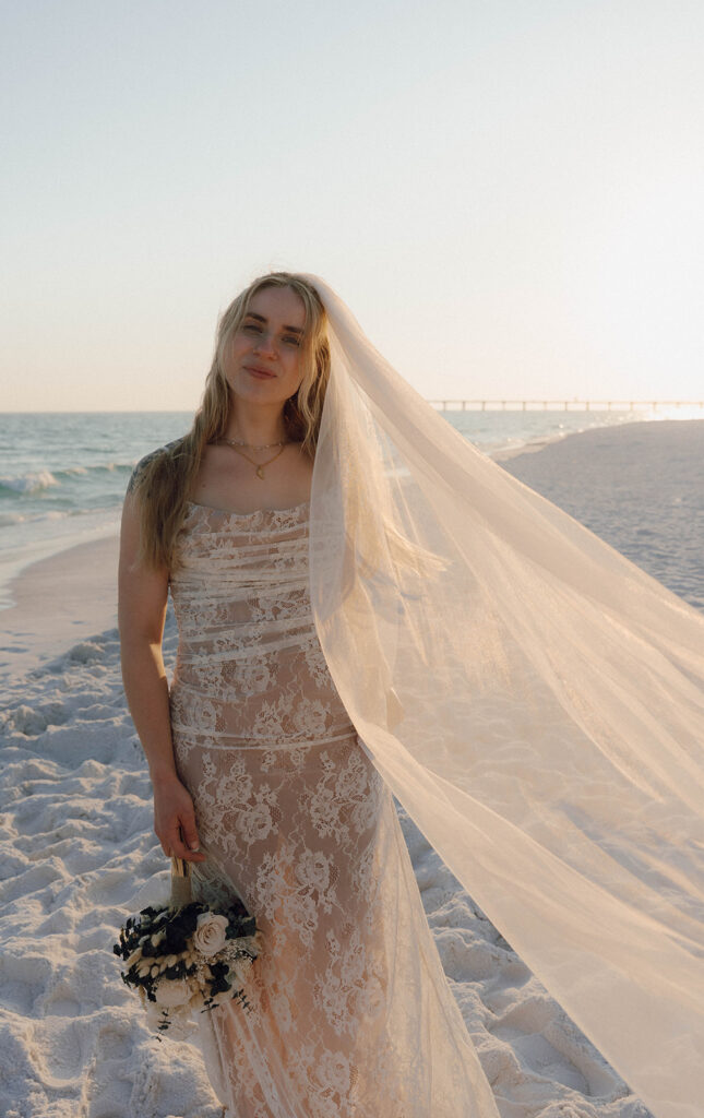 Bride with her veil flowing in the wind. 