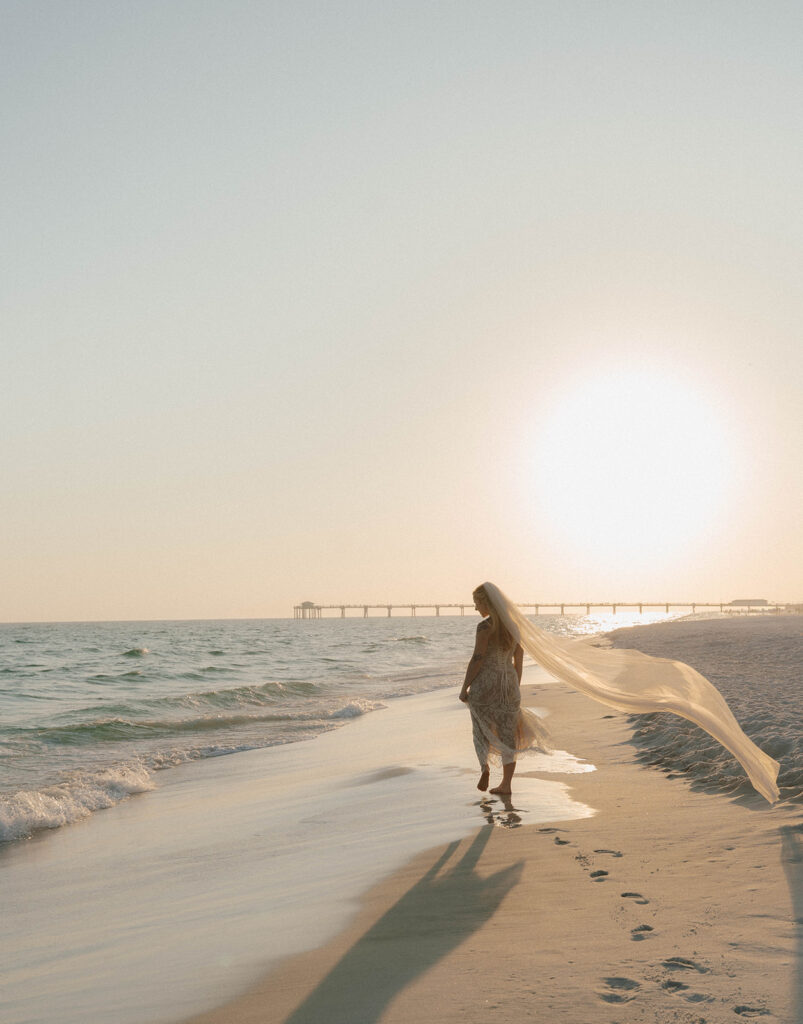 Bride walking along the beach.