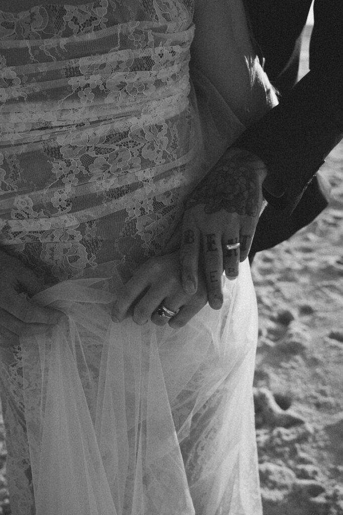 Groom holding his bride's hand.