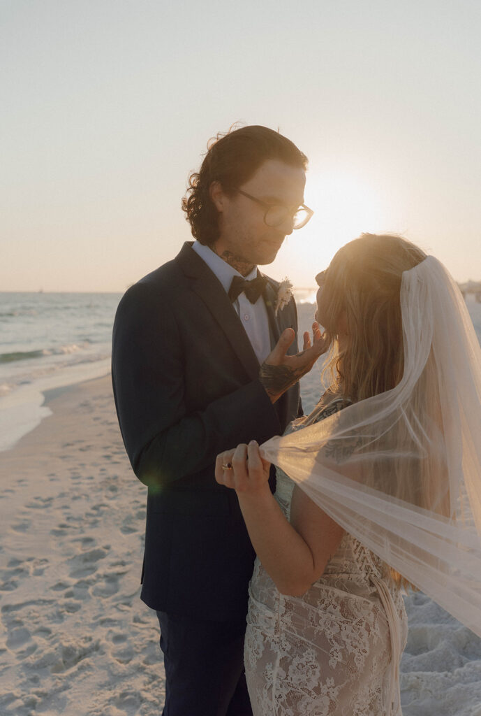 A groom holding his wife's face. 