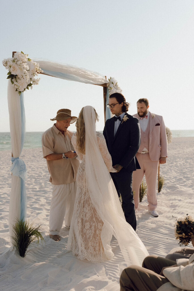 Bride and groom at the altar of their beach elopement.
