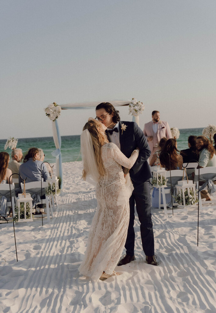 Bride and groom kissing at their beach elopement.