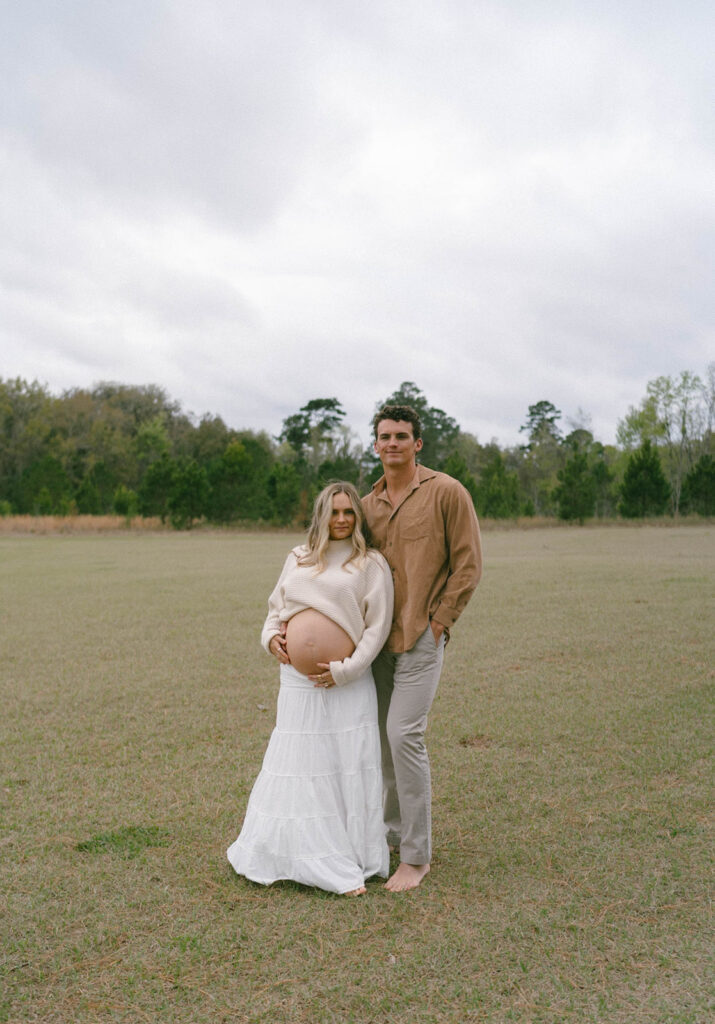 A couple posing for maternity photos.