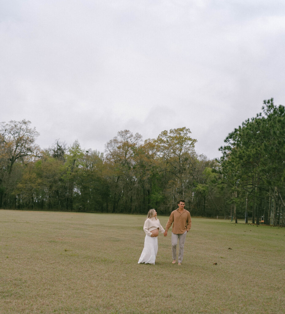 A couple walking around J.R. Alford Greenway for maternity photos.