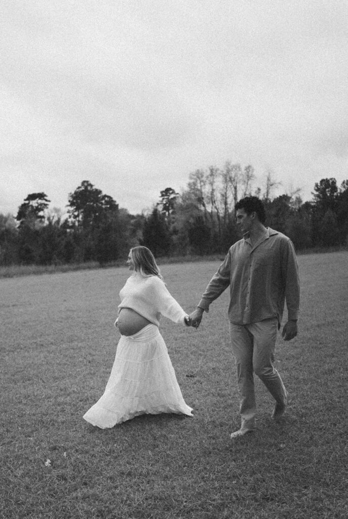 A couple walking through the open field at J.R. Alford Greenway.