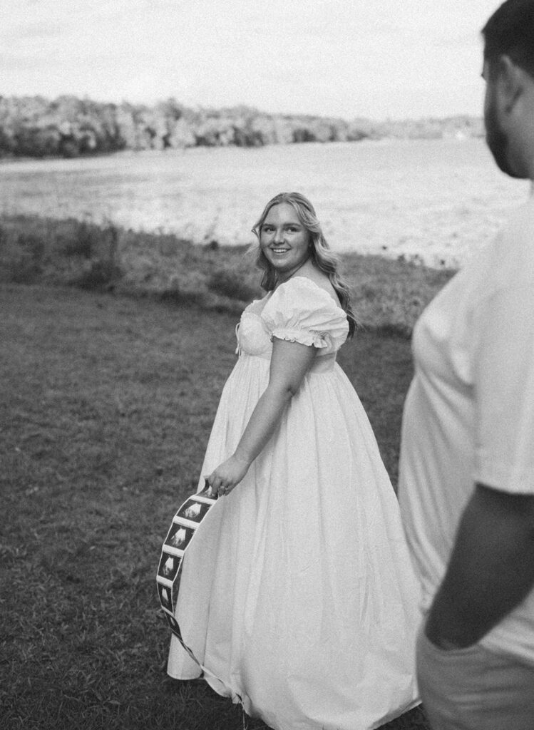 film photography maternity photoshoot with sonogram strip and picnic blanket