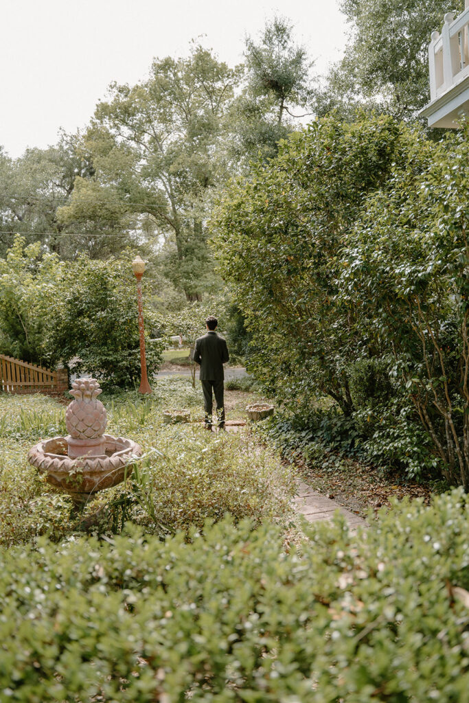 Groom standing in the garden at a Monticello wedding venue.